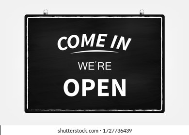 Text on vintage black sign "Come in we're open