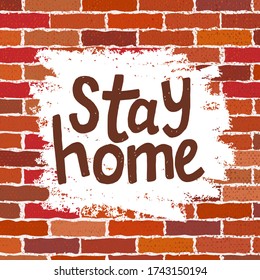 text Stay Home isolated on brick wall background. Handwriting lettering. Red brick wall with paint strokes texture or background with stains. Intrerior print, poster, postcard. corona, coronavirus
