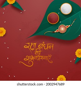 Text written in Hindi Language 'Raksha Bandhan Wishes' with top point of view of a Rakhi, and Tilak on Betel Leaf. Indian festival of Brother and Sister Bond. 