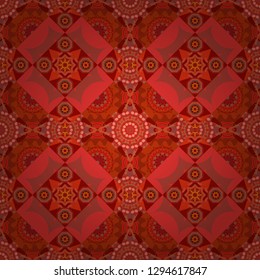 Textile fabric paper print. Colorful seamless pattern in mosaic style. Vector patchwork quilt pattern. Oriental ethnic ornament in red, orange and pink colors. Stylized floral doodle background.