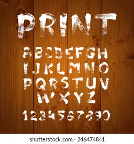Texture font written with paint and brushes on  realistic texture of brown wood