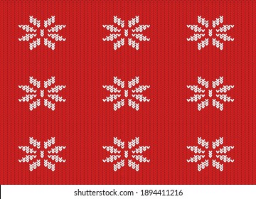textura de tejido rojo de punto con un patrón blanco en forma de copos de nieve