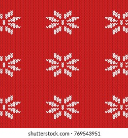 texture of a knitted red fabric with a white pattern in the form of snowflakes