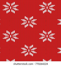 texture of a knitted red fabric with a white pattern in the form of snowflakes