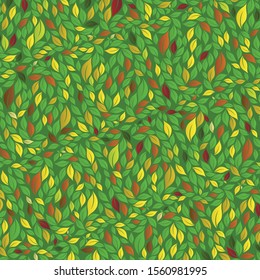 Texture of leaves of different size in green, yellow and orange colors on dark green background