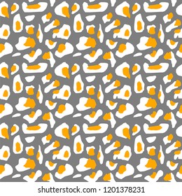 The texture of the leopard spots. Leopard pattern for textiles. White-yellow spots on a gray background.