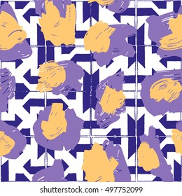The texture of the leopard spots. Leopard pattern for textiles. Yellow-purple spots on the background with blue geometric pattern.