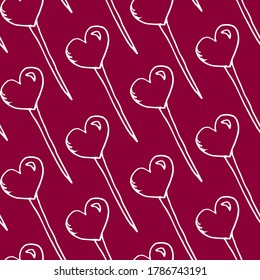 Texture of lollipops in the shape of a heart on a pink background. Cute contours of lollipops. Lollipops hearts
