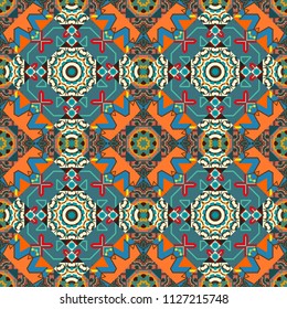 Texture, new background. Geometric stylized multicolored seamless pattern. Vector modern geometrical abstract background in blue, orange and brown colors.