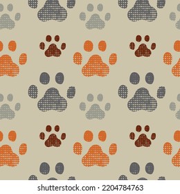 Textured animals paws prints seamless pattern. Dotted orange, brawn and grey footprints shape on beige background. Print for textiles and wallpaper. Vector illustration.
