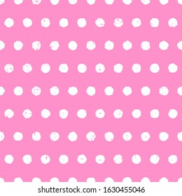 Textured polka dot white on pink background. Cute seamless pattern with aged effect. Hand drawn doodle style. Vector illustration.