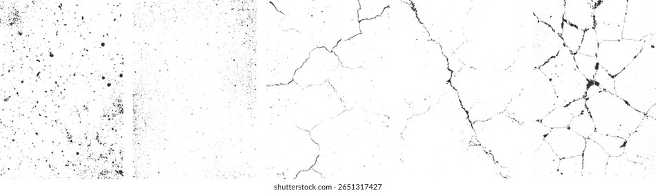 A textured surface with black cracks and scattered dark specks on a white background