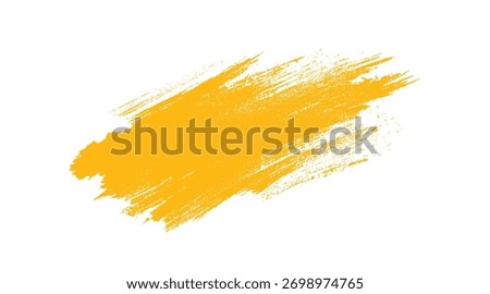 Textured yellow brush stroke with rough edges and scattered dots on a white background paint