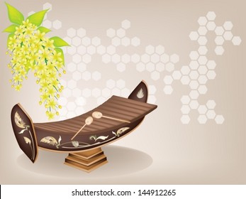 Thai Alto Xylophone and Yellow Color of Cassia Fistula or Golden Shower Flower on Brown Background. A traditional Thailand Musical Instrument Known as 'Ranad'  