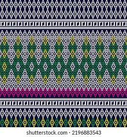 Thai fabric on a blue background, white, green, yellow, pink patterns