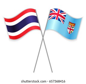 Thai and Fijian crossed flags. Thailand combined with Fiji isolated on white. Language learning, international business or travel concept.