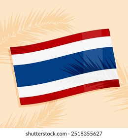 Die thailändische Flagge auf dem Sand, mit Schatten von den Palmenzweigen.