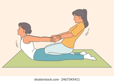 Thai massage for woman lying on floor, from girl masseur pulling patient hands to straighten spine. Massage in SPA salon to solve problems with back pain and improve well-being or rejuvenation