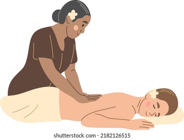 Thai massage. A woman from Thailand gives a massage to a female tourist.