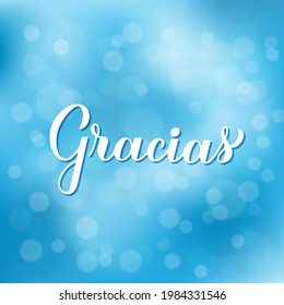 Thank you calligraphy hand lettering in Spanish language on blurred bokeh  background. Vector template for wedding thank you card, tag, banner, poster, label, etc.