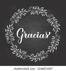 Thank you calligraphy hand lettering in Spanish language. Chalkboard background and floral wreath frame. Vector template for wedding thank you card, tag, banner, poster, label, etc.