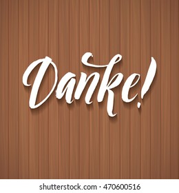 Thank You. Danke.   German Language White Vector Lettering on Wood Background