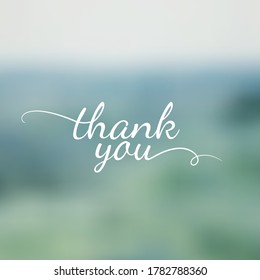 Thank you lettering on blurred nature background