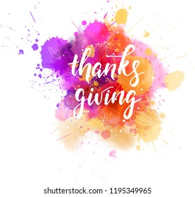 Thanks giving - handwritten modern calligraphy lettering text on abstract watercolor paint splash with floral decorations.