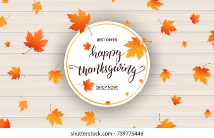 Thanksgiving card. Happy Thanksgiving calligraphy and falling autumn leaves on wooden background. Thanksgiving Day banner.