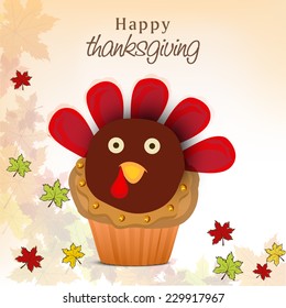 Thanksgiving Day celebration concept with cupcake in turkey shape on colorful maple leaves decorated background. 