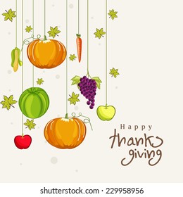 Thanksgiving Day celebration concept with stylish hanging vegetables, fruits and maple leaves on beige background.