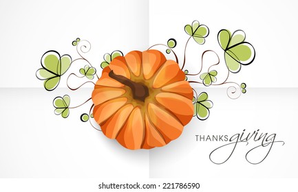 Thanksgiving Day festival celebration greeting card with pumpkin and beautiful green floral design. 