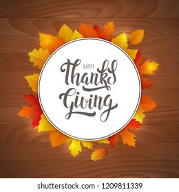 Thanksgiving day lettering poster. Vector vintage card with hand written calligraphy logo and autumn leaves on wooden background.