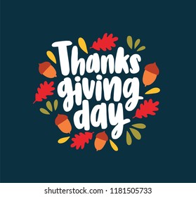 Thanksgiving Day lettering written with elegant cursive calligraphic font and decorated by fallen autumn leaves and acorns. Bright colored seasonal vector illustration in flat style for greeting card.