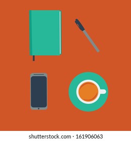 There are a cup of juice, a notepad with a pen and a phone on the table. Break for a cup of juice at the workplace.