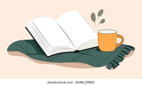There is an open book on a green blanket.
