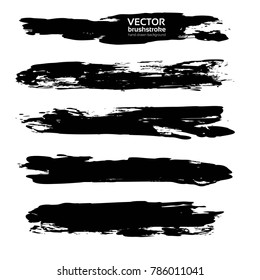 Thick long abstract black hand-drawn brush strokes isolated on a white background