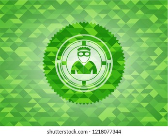 thief icon inside green emblem with triangle mosaic background