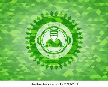 thief icon inside green emblem with triangle mosaic background