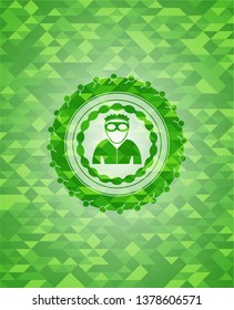 thief icon inside green emblem with triangle mosaic background