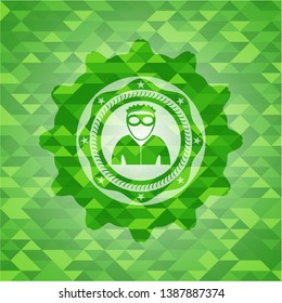 thief icon inside green emblem with mosaic background
