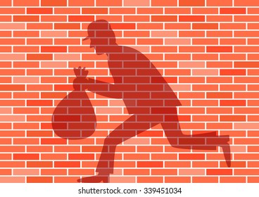 Thief shadow on brick wall