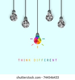 Think different concept with creative and colorful lightbulb being more unique than the surrounding grey ones