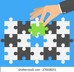 Think different concept. Hand putting or replacing green puzzle piece in a black and white pattern. Flat design