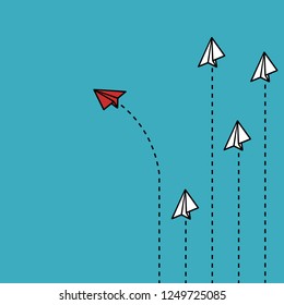 Think different concept- red paper plane changing direction from white paper planes
