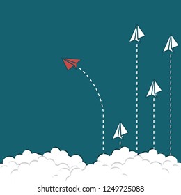Think different concept- red paper plane changing direction from white paper planes