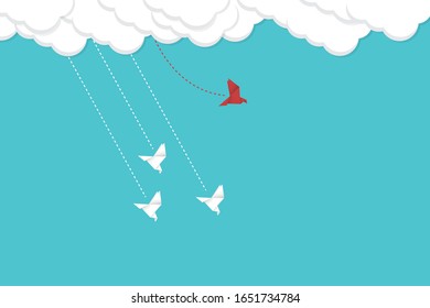 Think differently concept. Be different. Red bird changing direction. New idea, change, trend, courage, creative solution, innovation and unique way concept.