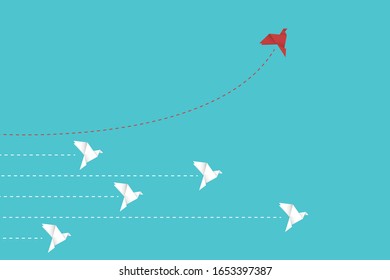 Think differently concept. Be different. Red paper bird changing direction. New idea, change, trend, courage, creative solution, innovation and unique way concept.