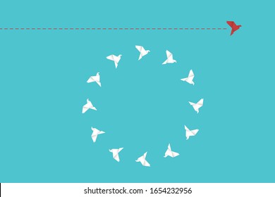 Think differently concept. Be different. Red bird changing direction. New idea, change, trend, courage, creative solution, innovation and unique way concept.