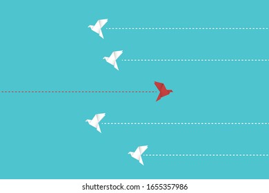 Think differently concept. Be different. Red bird changing direction. New idea, change, trend, courage, creative solution, innovation and unique way concept.